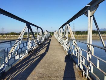 View of footbridge against clear sky