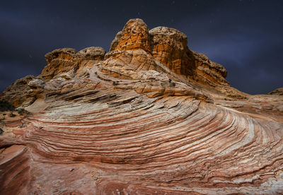 Strange rock formations in under a night sky in white pocket ari