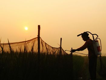 Man spraying insecticide on agricultural field