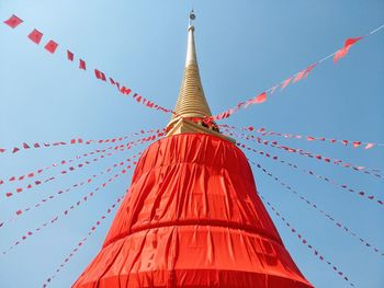 Low angle view of red flags against sky
