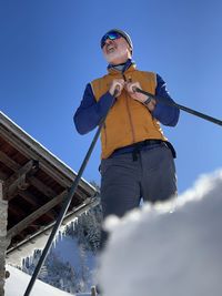 Low angle view of snow covered mountain against sky