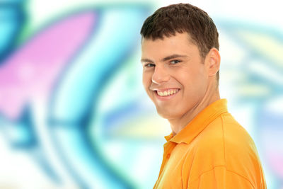 Portrait of smiling man standing against blurred background