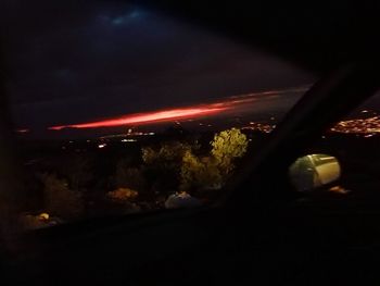 Illuminated car against sky at night