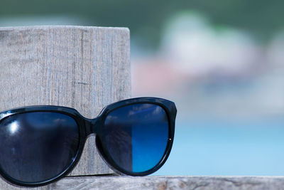 Close-up of sunglasses against sky