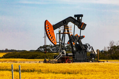 Traditional windmill on field against sky