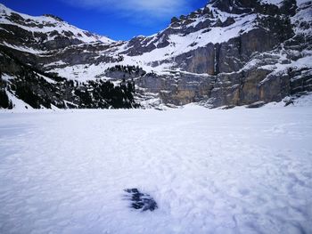 Scenic view of snow covered field against sky