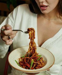 Midsection of woman having food