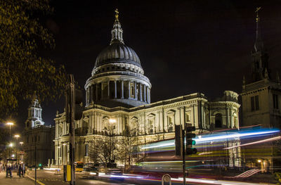 Illuminated buildings in city against sky at night