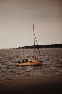 Sailboat sailing on sea against sky