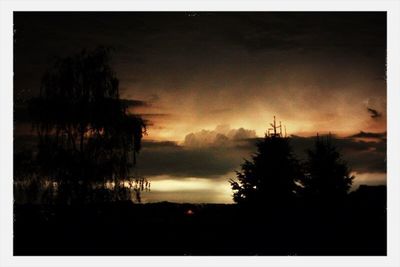 Silhouette of landscape against cloudy sky