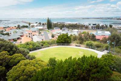 High angle view of townscape by river against sky