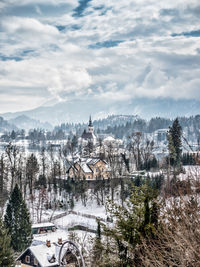 Houses and buildings against sky during winter