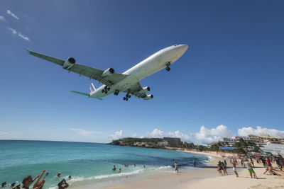 People on beach against sky