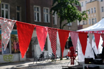 Close-up of red bunting flags hanging in city