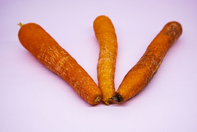 High angle view of orange leaf on white background