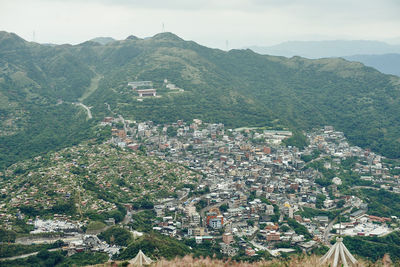 High angle view of townscape and mountains against sky