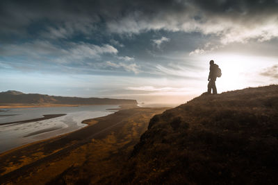 Silhouette of woman standing on beach