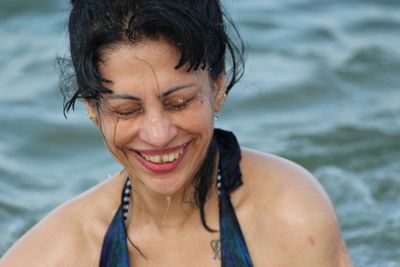 Portrait of a smiling young woman in sea