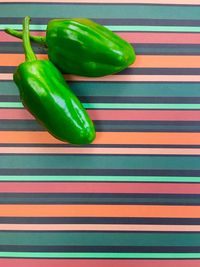 Peppers on high angle view of multi colored background