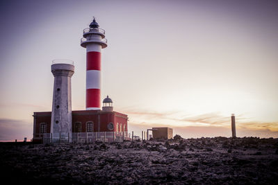 Low angle view of lighthouse against sky during sunset