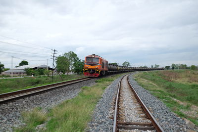 Train on railroad track against sky