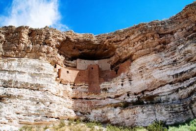 Low angle view of rock formations against sky
