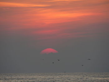 Scenic view of sea against sky at sunset