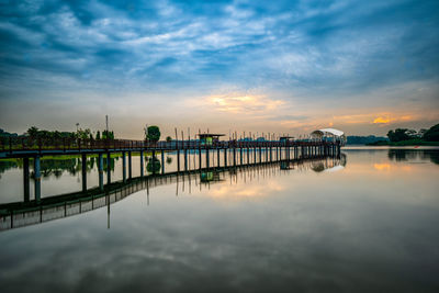 Bridge over river against sky during sunset