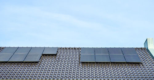 Low angle view of roof against clear blue sky