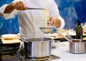 Midsection of man preparing food in kitchen