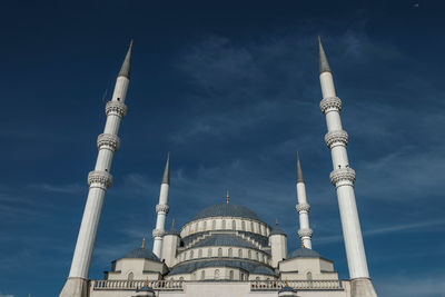 Low angle view of mosque building against blue sky in ankara