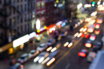 Defocused image of illuminated city street at night