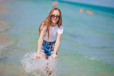 Portrait of young woman swimming in sea