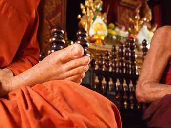 A buddhist monk sitting in the lotus position at a temple in bangkok, thailand.