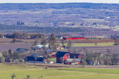 Scenic view of landscape and houses against clear sky