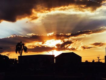 Silhouette buildings against sky during sunset