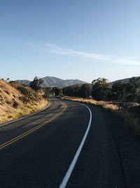 Empty road leading towards mountains