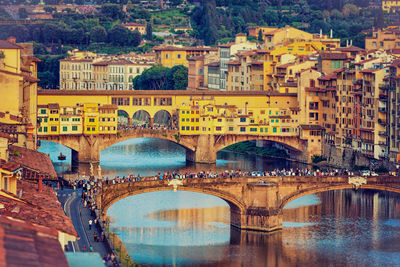 Arch bridge over river in city