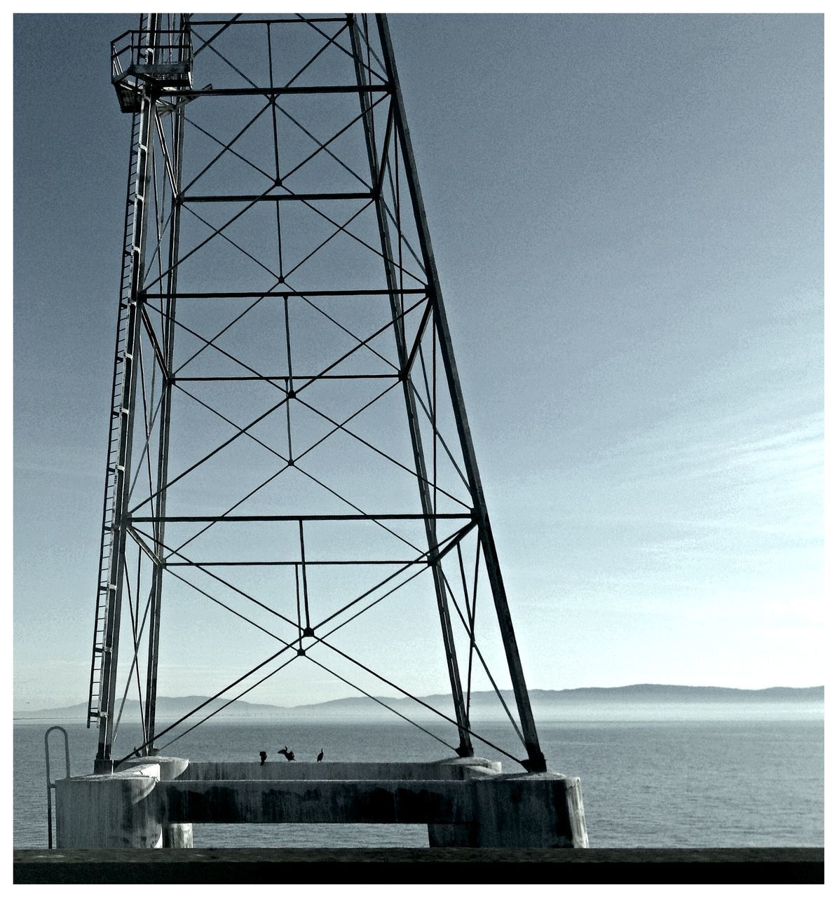 transfer print, connection, built structure, sky, auto post production filter, water, architecture, sea, engineering, low angle view, metal, development, waterfront, outdoors, no people, suspension bridge, day, blue, travel destinations, crane - construction machinery