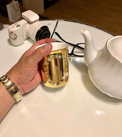 High angle view of hand holding food on table