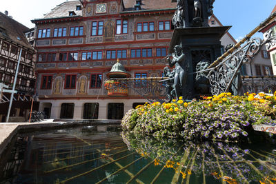 Sculpture of building by canal