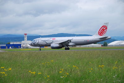 Airplane on field against sky