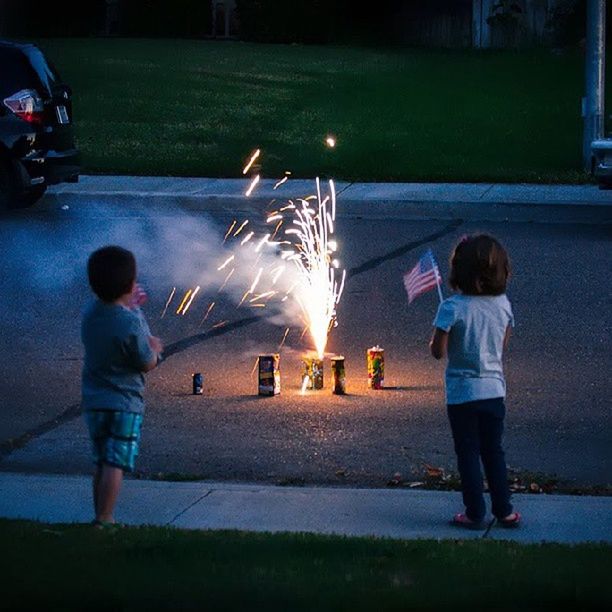 full length, childhood, lifestyles, boys, casual clothing, girls, night, leisure activity, elementary age, street, illuminated, rear view, togetherness, motion, innocence, standing, playing