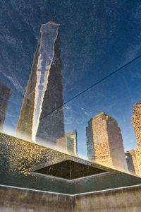 Low angle view of modern building against blue sky