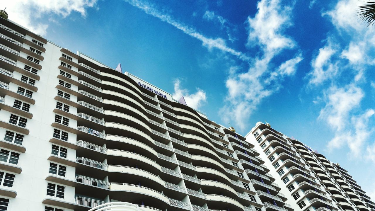 building exterior, architecture, built structure, low angle view, sky, city, modern, building, office building, blue, window, cloud, day, cloud - sky, outdoors, residential building, tall - high, residential structure, reflection, no people