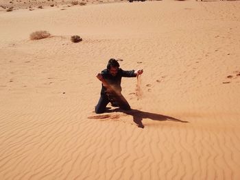 Full length of man on sand at beach