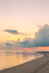 Scenic view of beach against sky during sunset