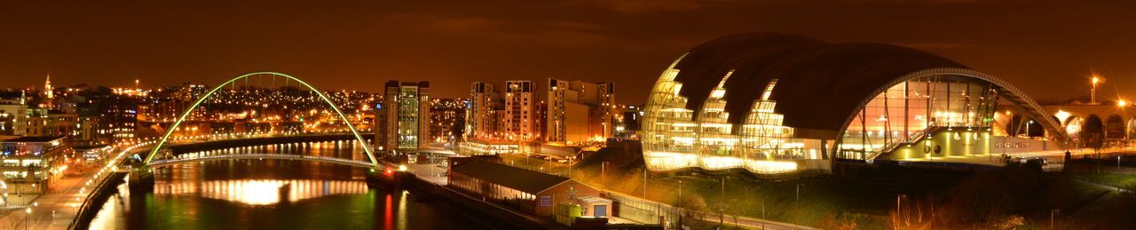 Illuminated cityscape against sky at night