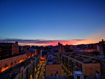 High angle view of illuminated city against clear sky