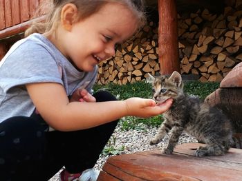 Cute girl playing with kitten